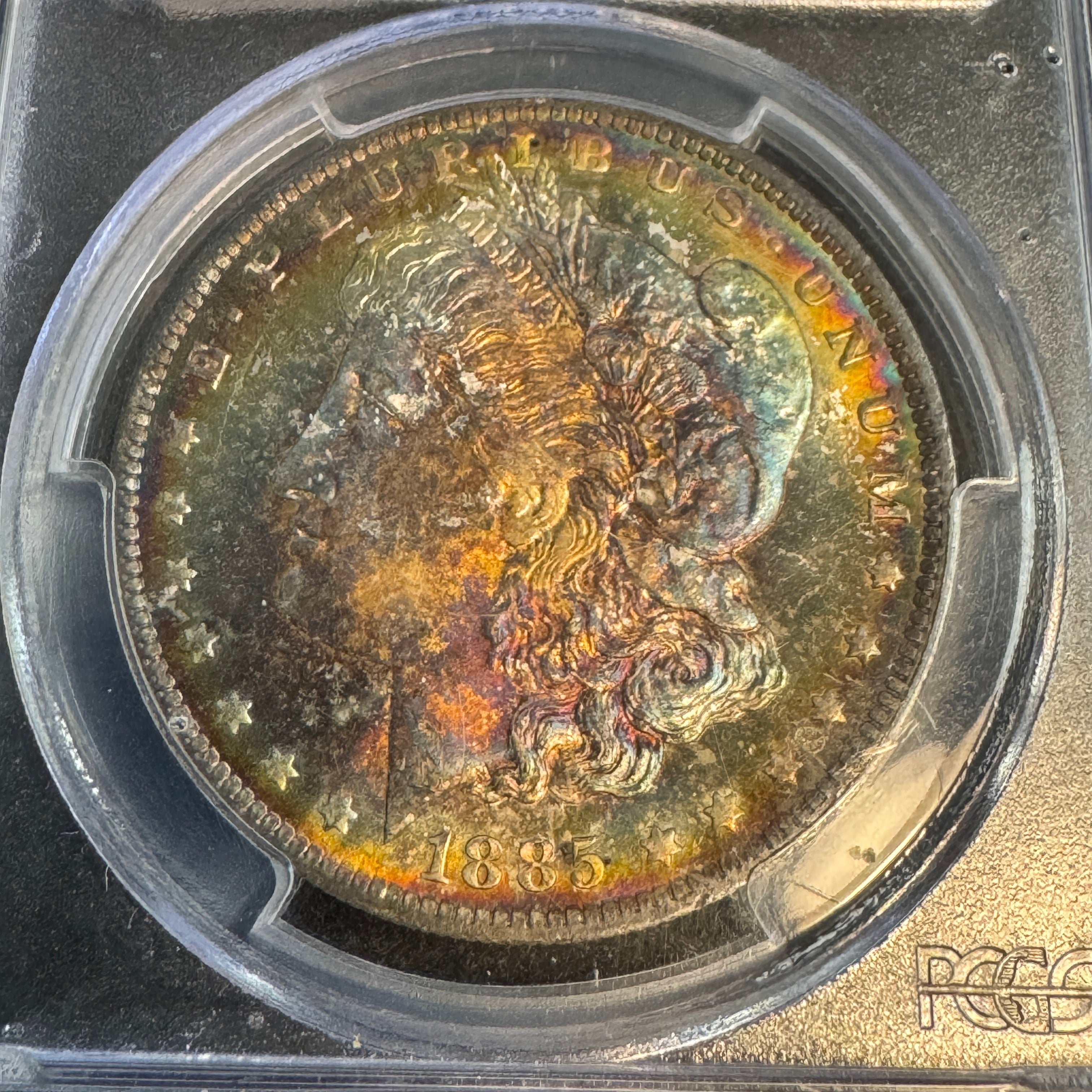 1885-O Morgan Silver Dollar, Rainbow Toned, PCGS MS-65+ Green CAC approved