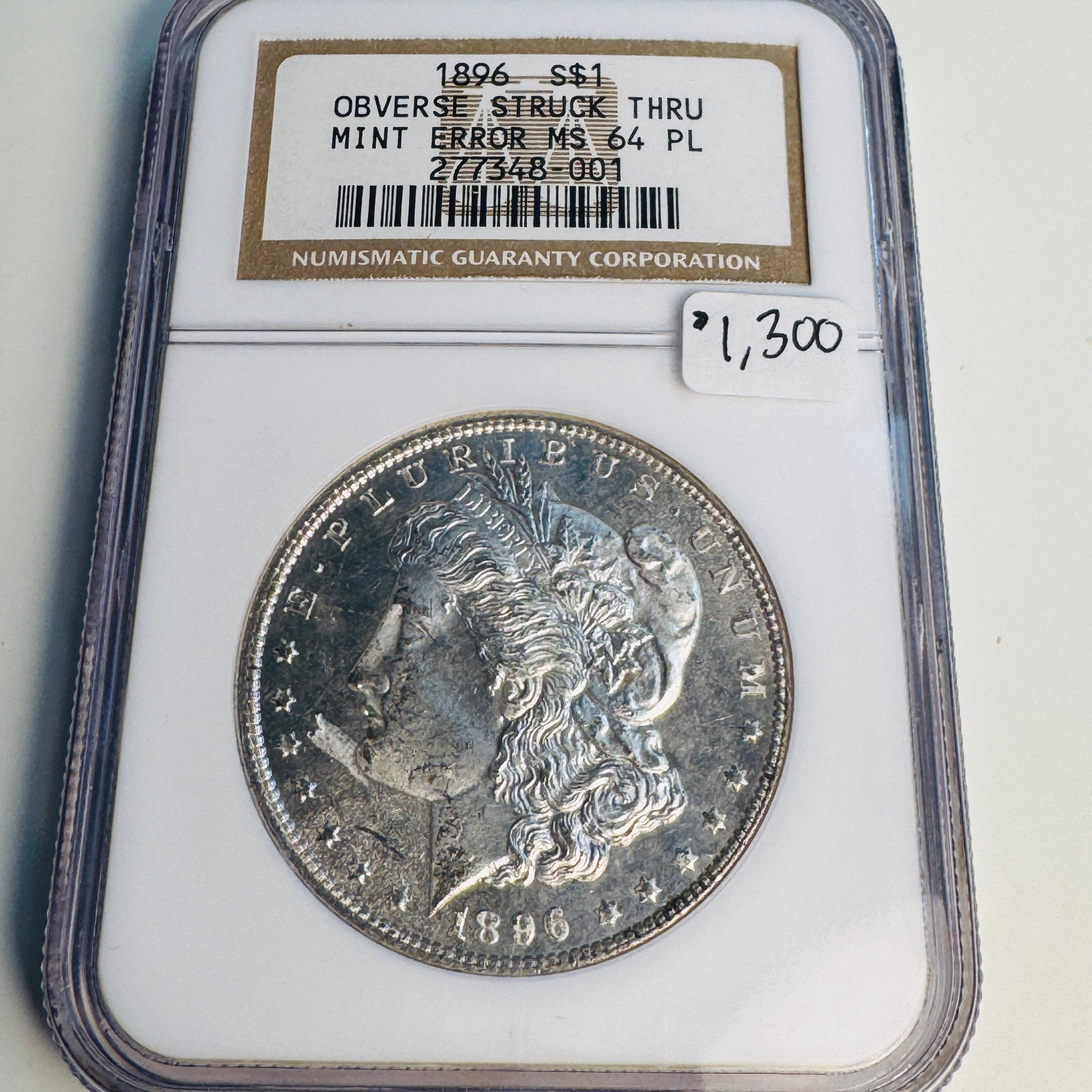 1896 (P) Mint Error Morgan Silver Dollar, Obverse Struck Thru (Debris), NGC MS-64 PL