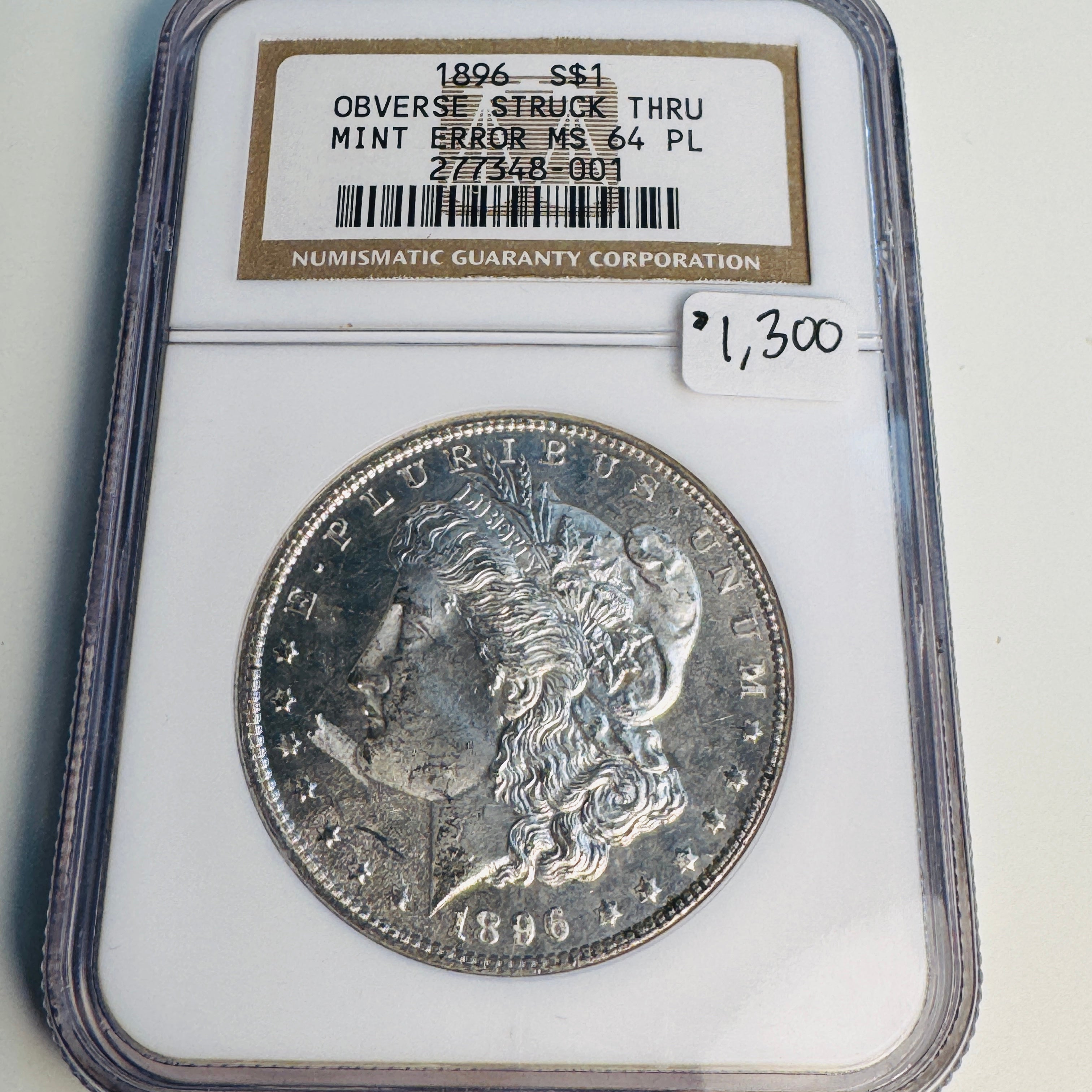 1896 (P) Mint Error Morgan Silver Dollar, Obverse Struck Thru (Debris), NGC MS-64 PL