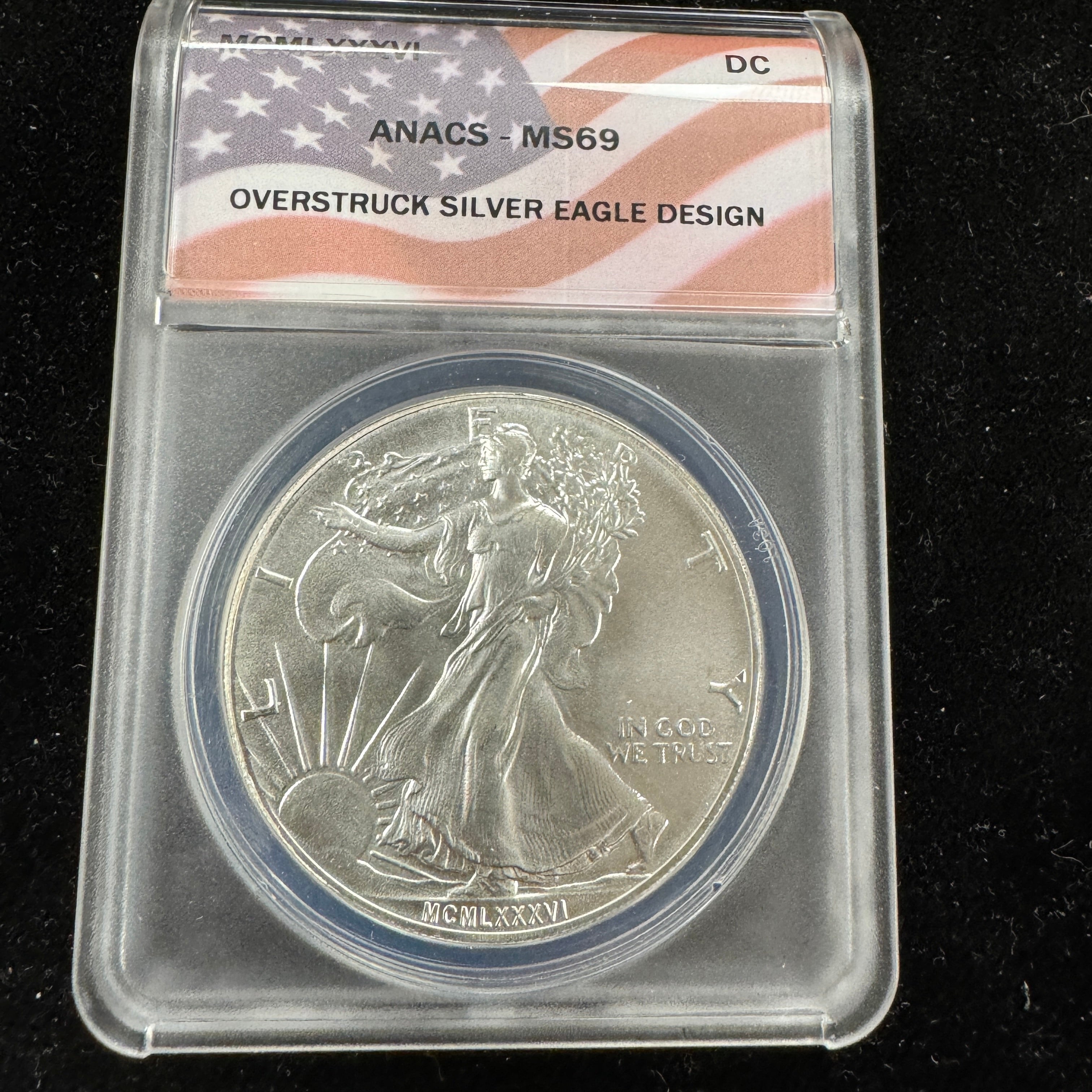 MCMLXXXVI (1986) Daniel Carr Overstruck ASE Design, US Silver Eagle, ANACS MS-69