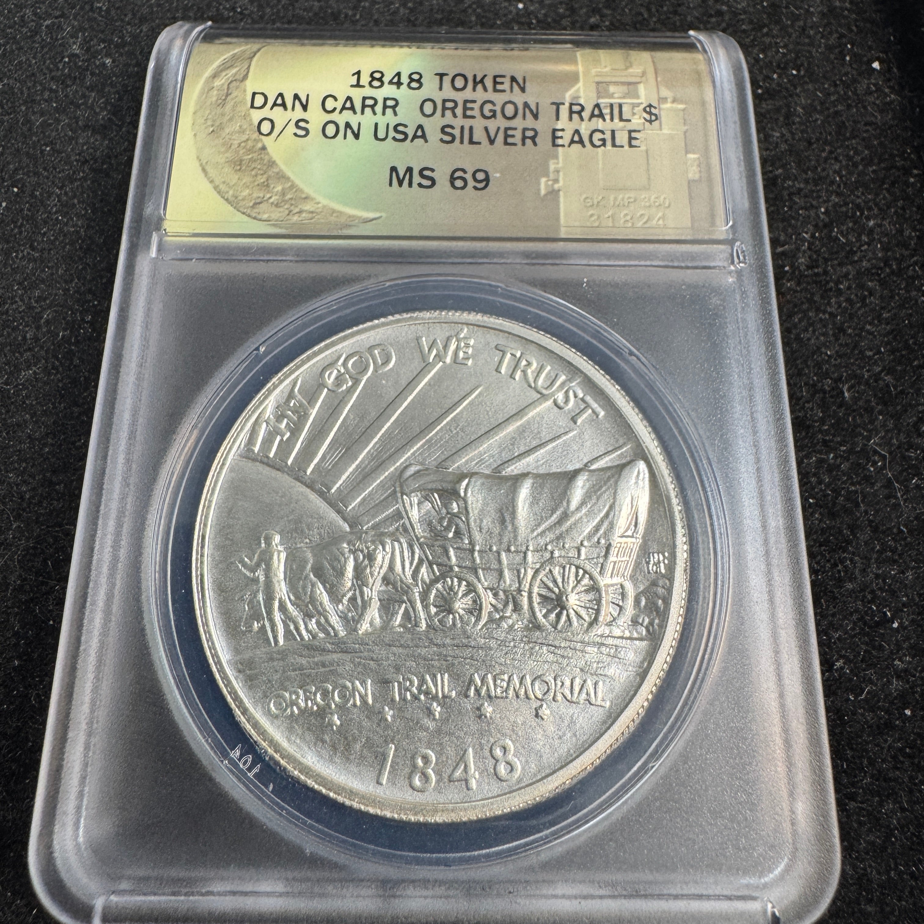 “1848” Daniel Carr Oregon Trail O/S on 1oz US Silver Eagle Host, ANACS MS-69