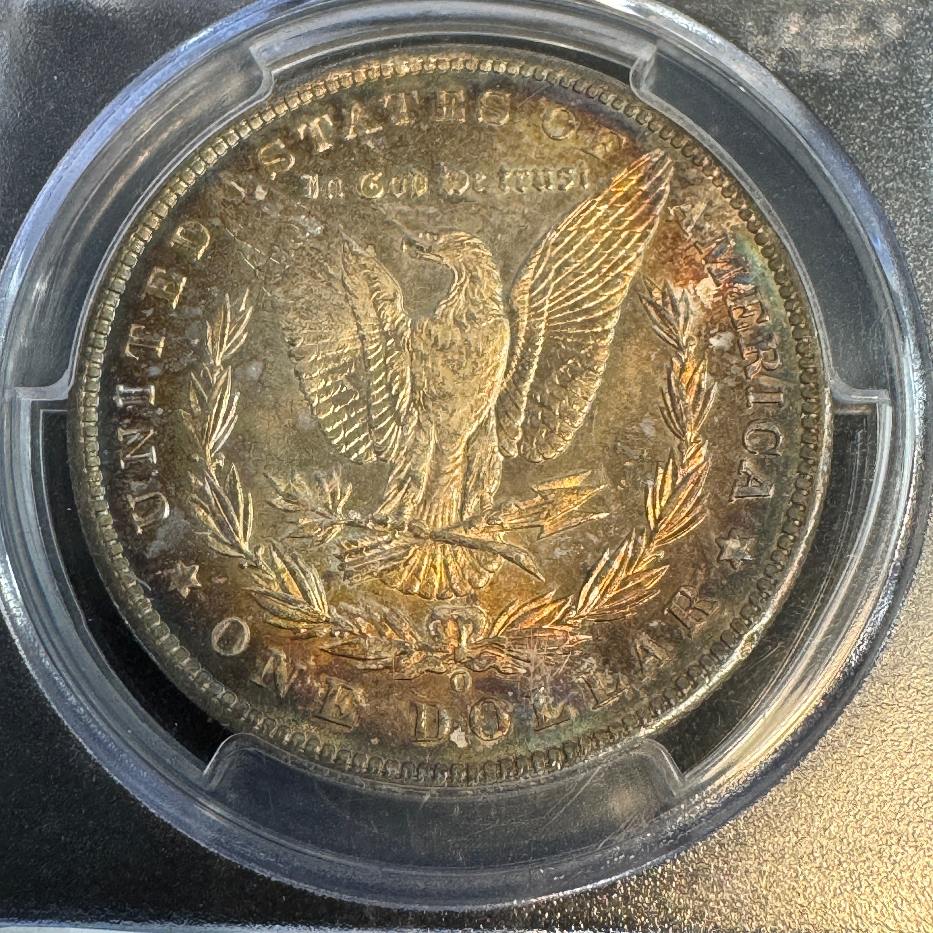 1885-O Morgan Silver Dollar, Rainbow Toned, PCGS MS-65+ Green CAC approved