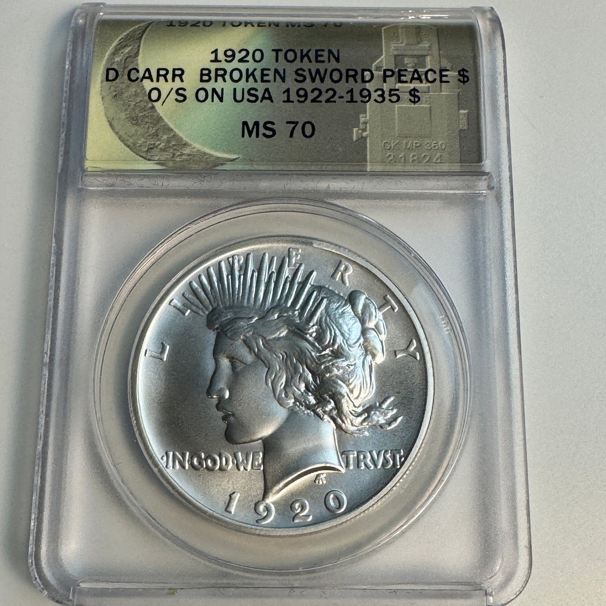 “1920” Daniel Carr Broken Sword Peace Dollar O/S on US Peace Dollar (1922-35) Host, ANACS MS-70