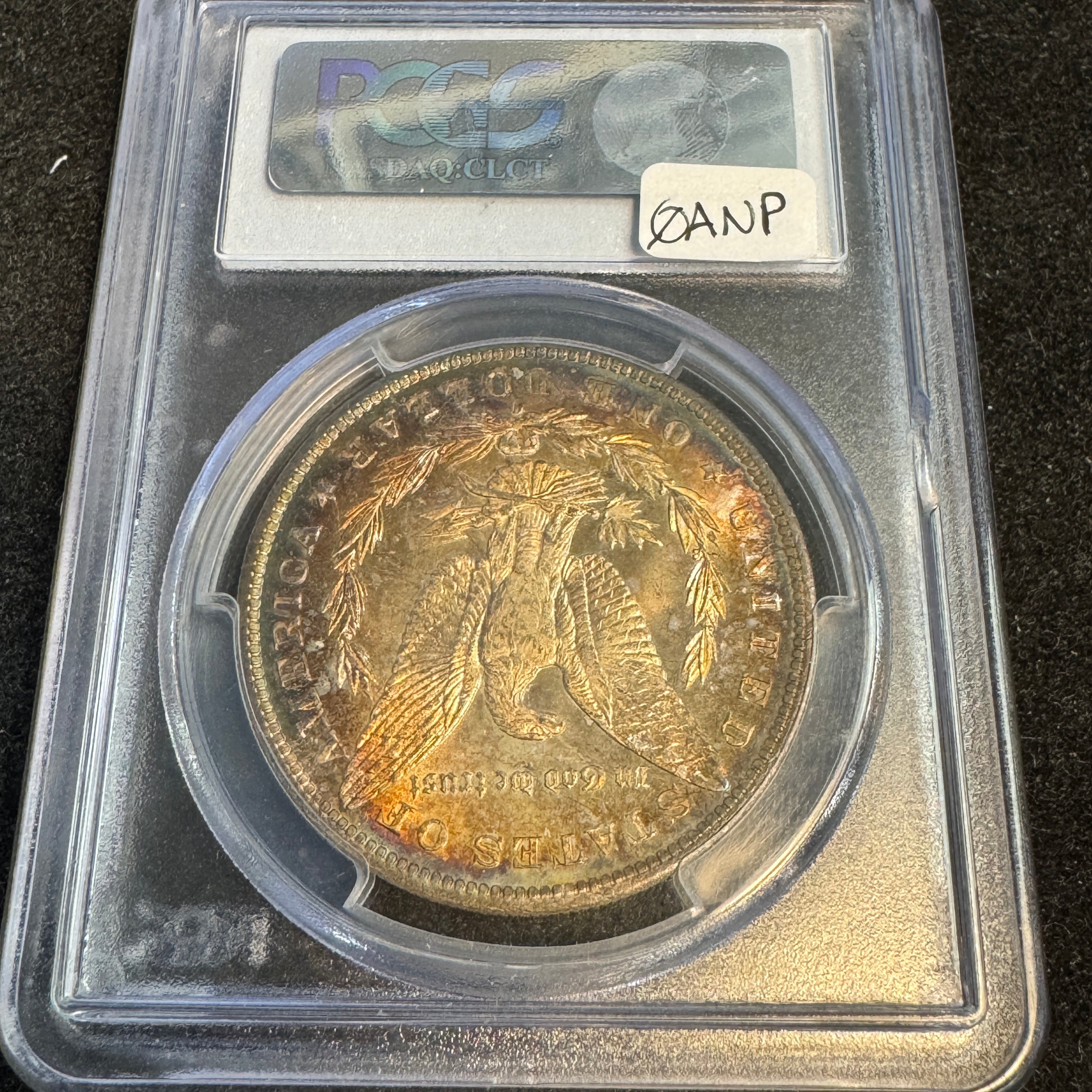 1885-O Morgan Silver Dollar, Rainbow Toned, PCGS MS-65+ Green CAC approved